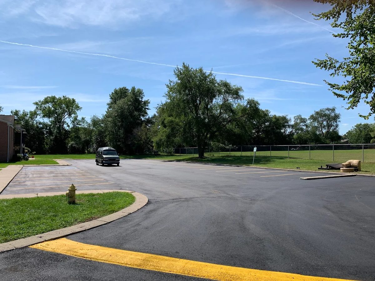 Parking lot with fresh asphalt and painted curb