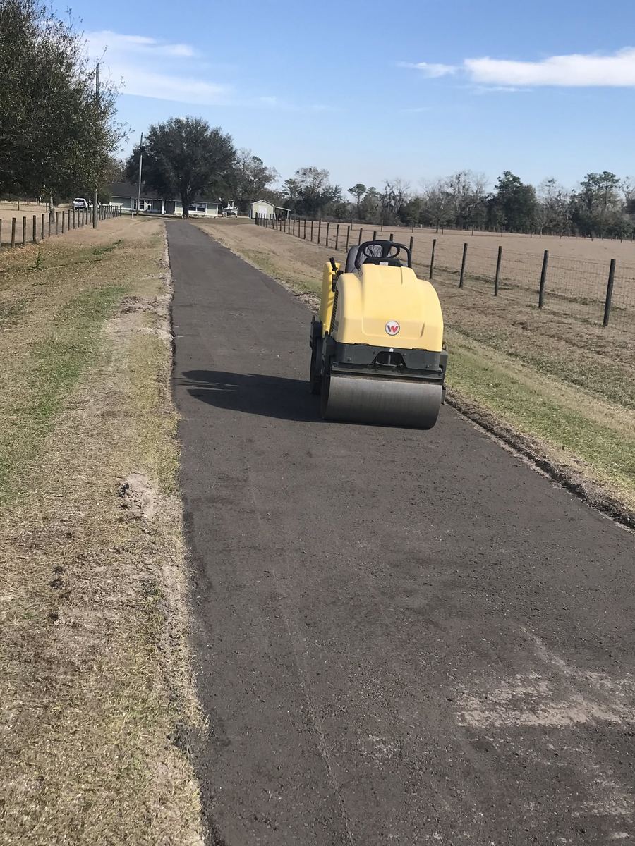 Roller compacting fresh asphalt on a paving job