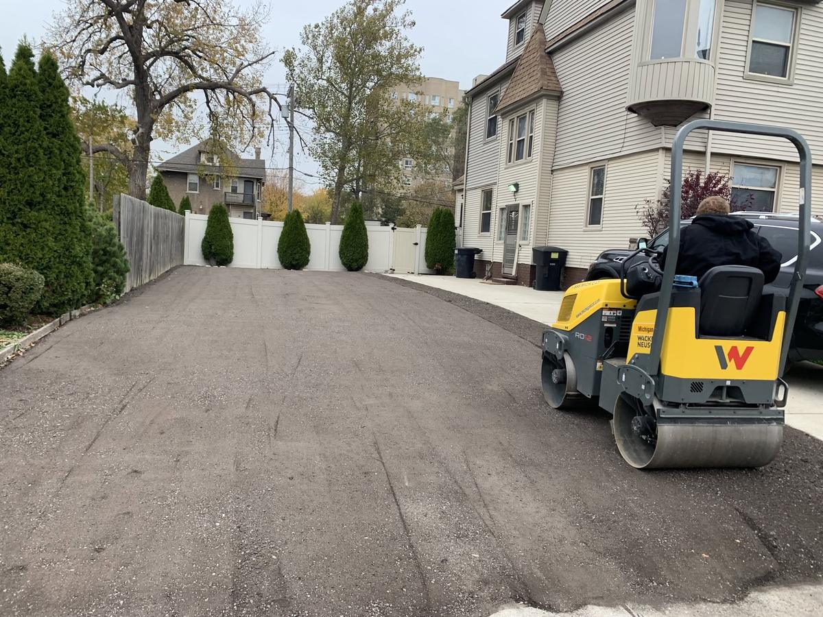 Black Rock Paving crew rolling fresh asphalt in Southeast Michigan